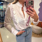 Witte ruffle blouse met borduursel